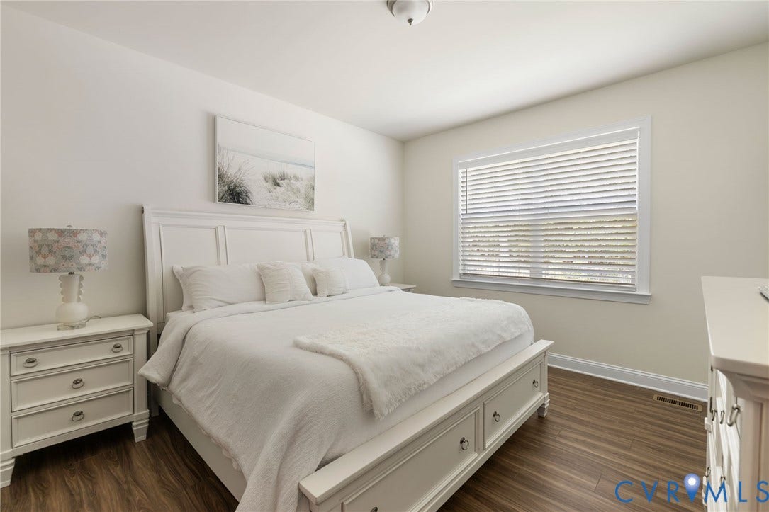 Wood-finish flooring, large window with blinds, recessed lighting, and light-toned walls
