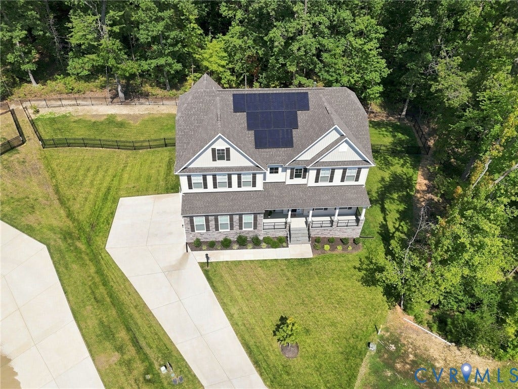 Two-story residence featuring a gabled roofline and multiple solar panels