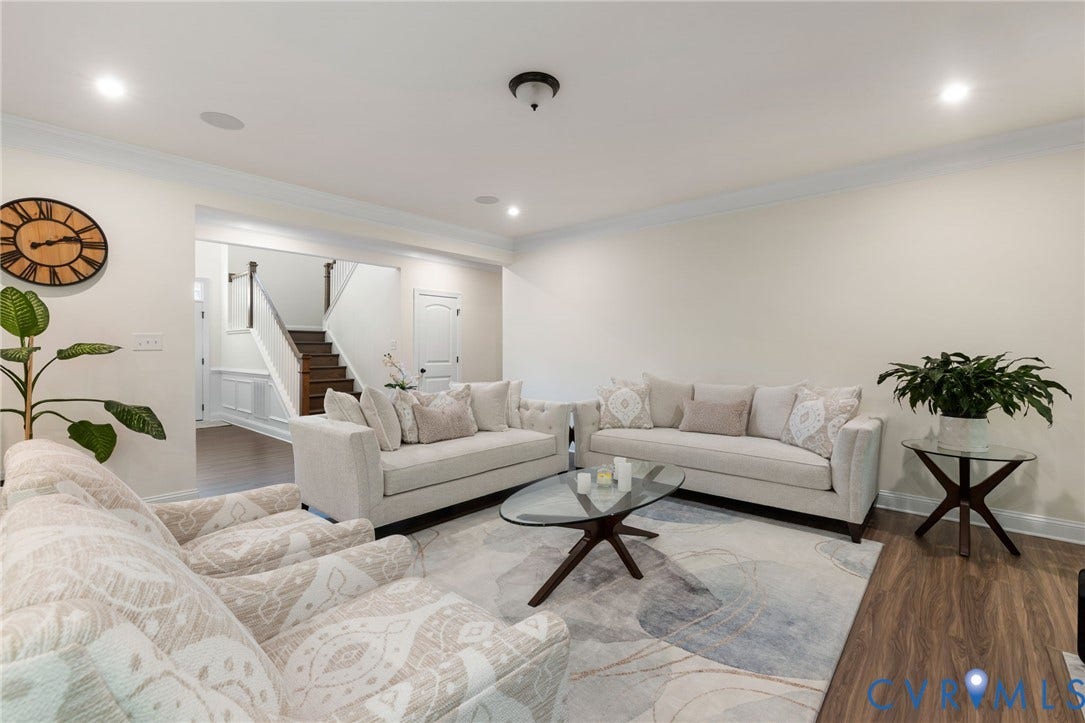 Recessed lighting, crown molding, wood-finish flooring, white walls, and a staircase with dark wood treads