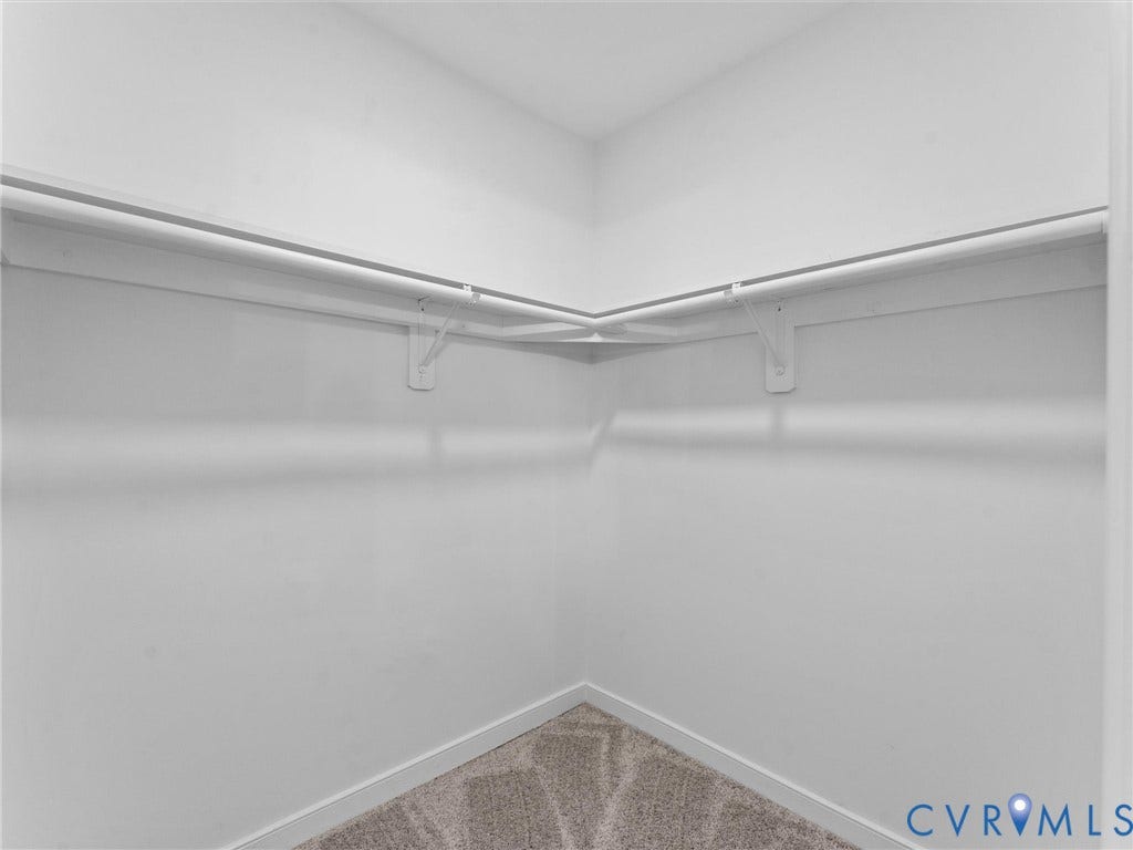3626 Reynolds Road, Richmond, VA 23223 Walk-in closet featuring white wire shelving, white hanging rods, and neutral-toned carpeting