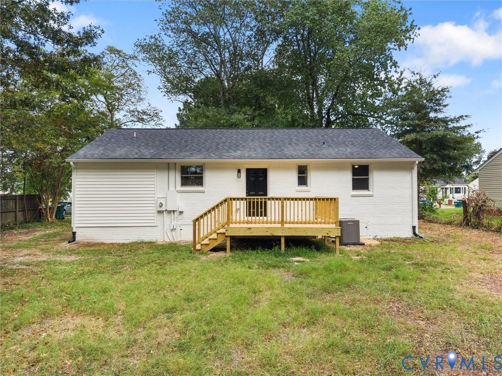 3626 Reynolds Road, Richmond, VA 23223 White brick exterior with a wood deck featuring stairs and railings