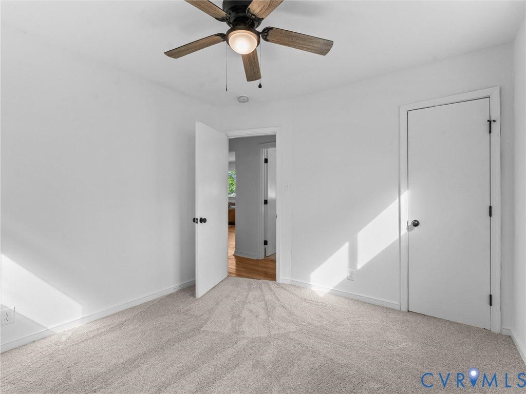3626 Reynolds Road, Richmond, VA 23223 Neutral-toned carpeting, white walls, and a ceiling fan with light fixture