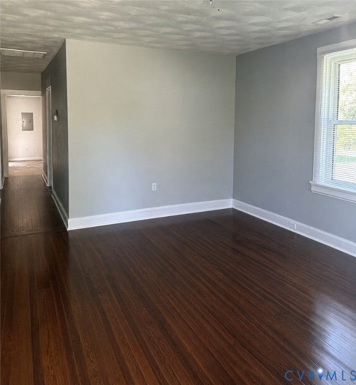 4307 3rd Street, Richmond, VA 23223 Rich wood-finish flooring, light gray walls, white trim, and a window with blinds
