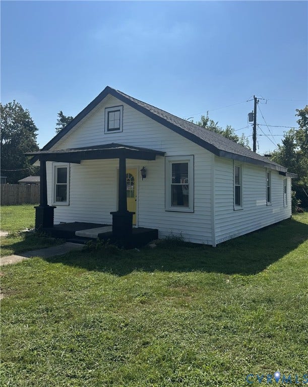 4307 3rd Street, Richmond, VA 23223 White siding exterior with a contrasting dark roof and porch columns