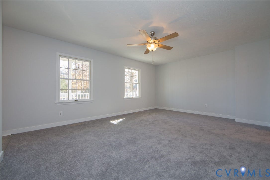 19224 Maurer Lane, Colonial Heights, VA 23834 Expansive room featuring carpet flooring, two sash windows, a ceiling fan with integrated lighting, and white trim