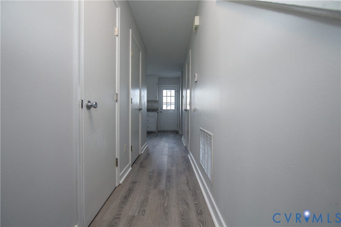 19224 Maurer Lane, Colonial Heights, VA 23834 Hallway featuring wood-finish flooring, light neutral wall paint, and white trim