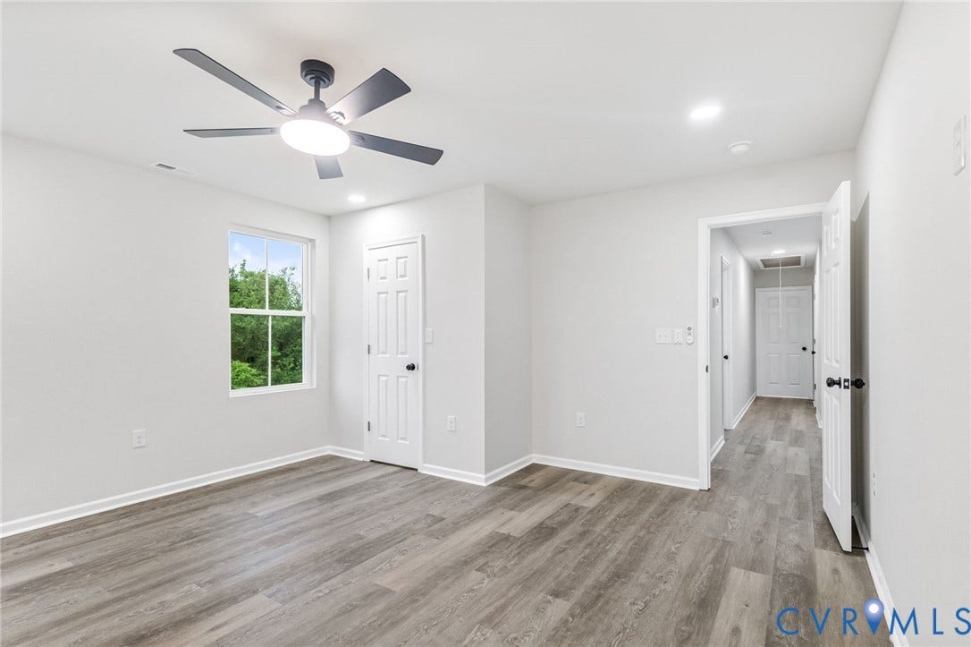Recessed lighting, wood-finish flooring, ceiling fan with integrated light, and white paneled doors