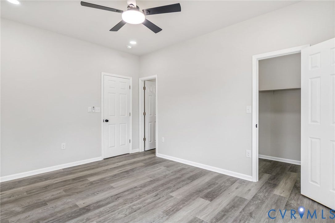 Wood-finish flooring, recessed lighting, and a ceiling fan with integrated lighting