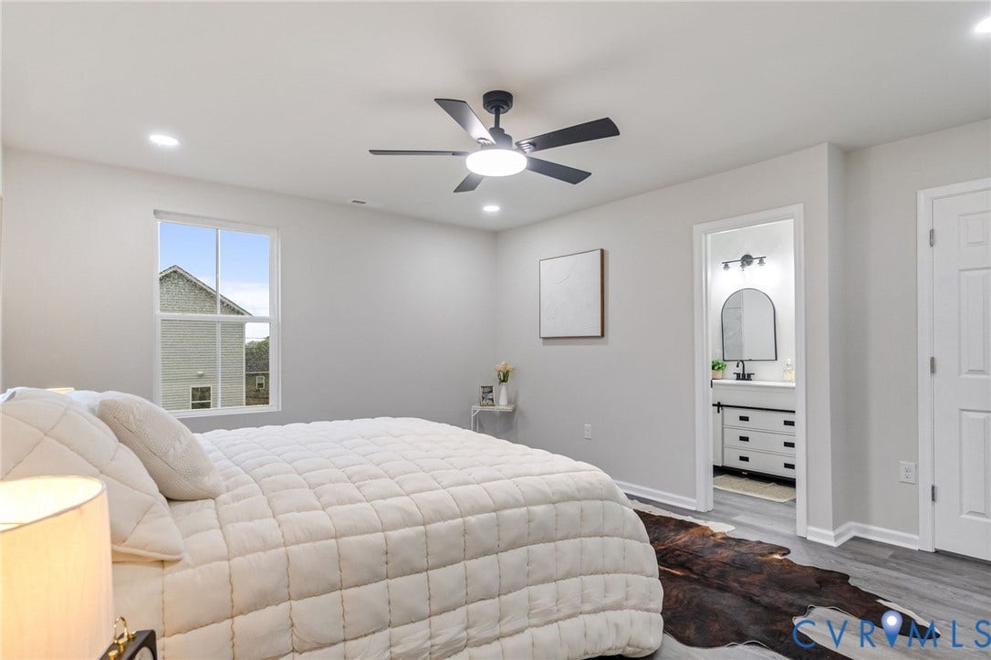 White walls featuring a black ceiling fan, recessed lighting, and a single window