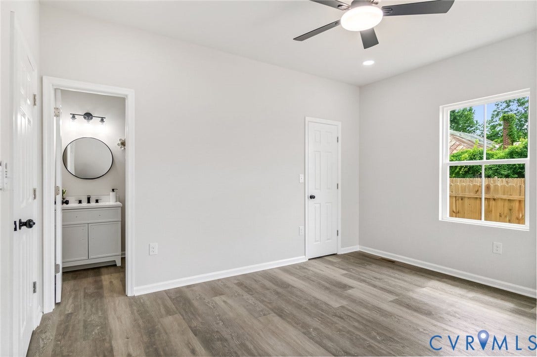 Wood-finish flooring with white walls and trim