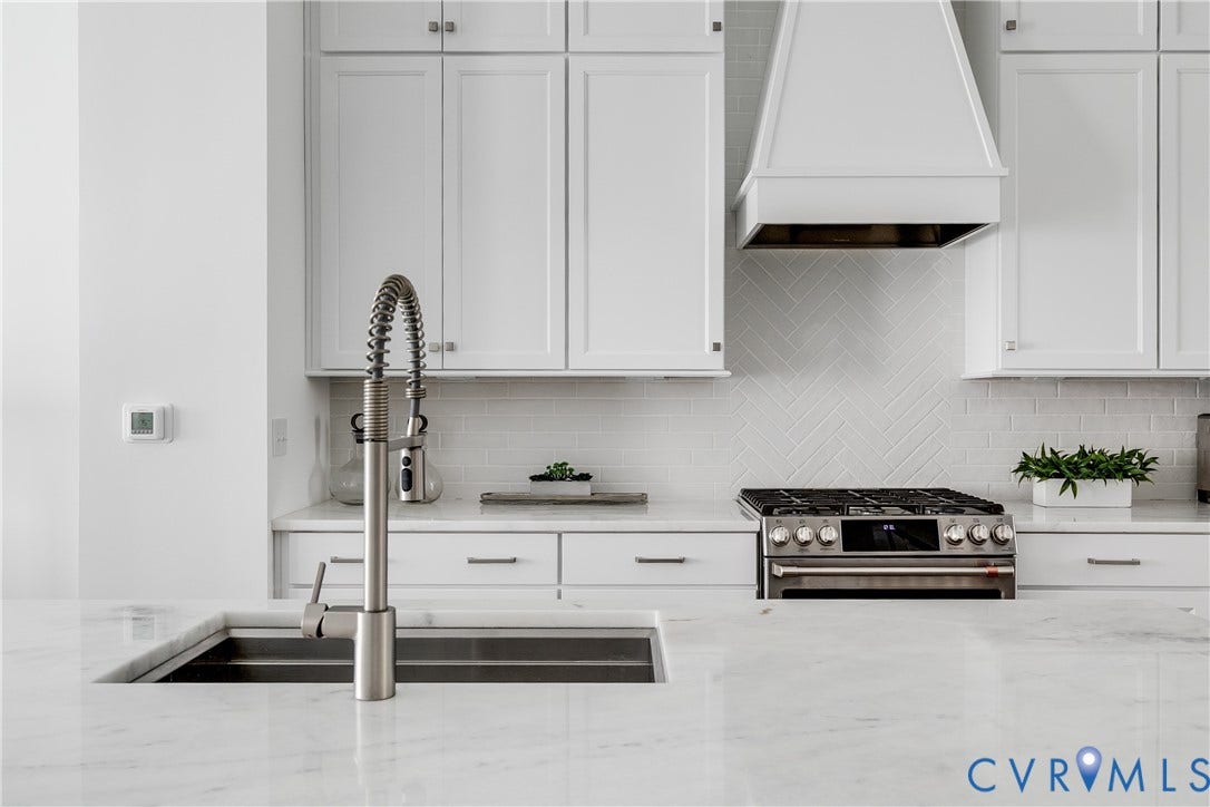 Beautiful marble countertops, range hood, and SS Appliances