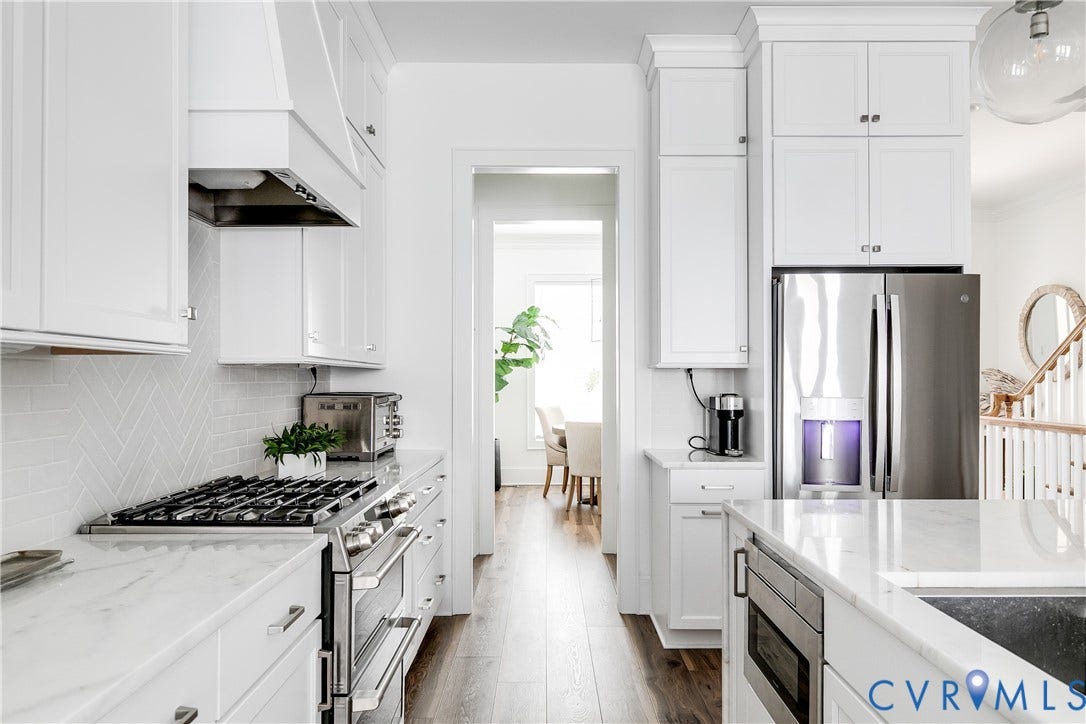 Beautiful marble countertops, range hood, and SS Appliances