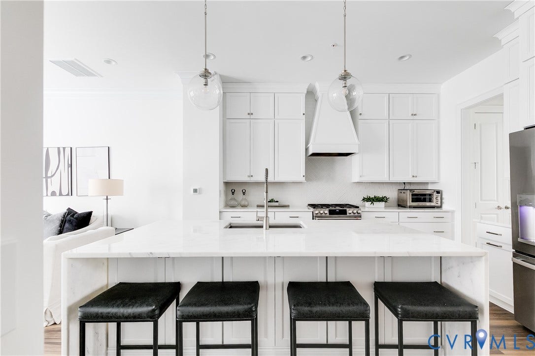 Beautiful marble countertops, range hood, and SS Appliances