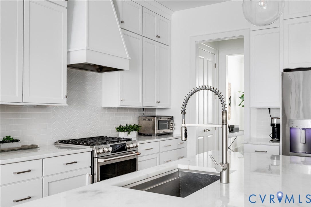 Beautiful marble countertops, range hood, and SS Appliances
