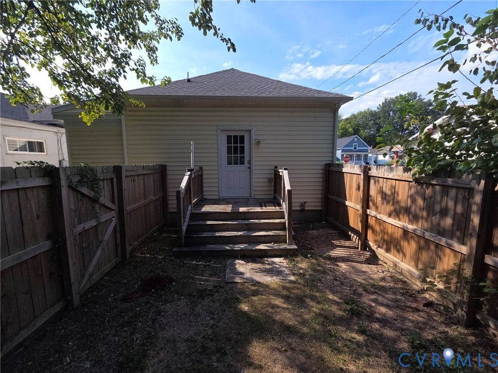 3400 Decatur Street, Richmond, VA 23224 Rear exterior with light-colored siding, leading to a wooden deck with steps