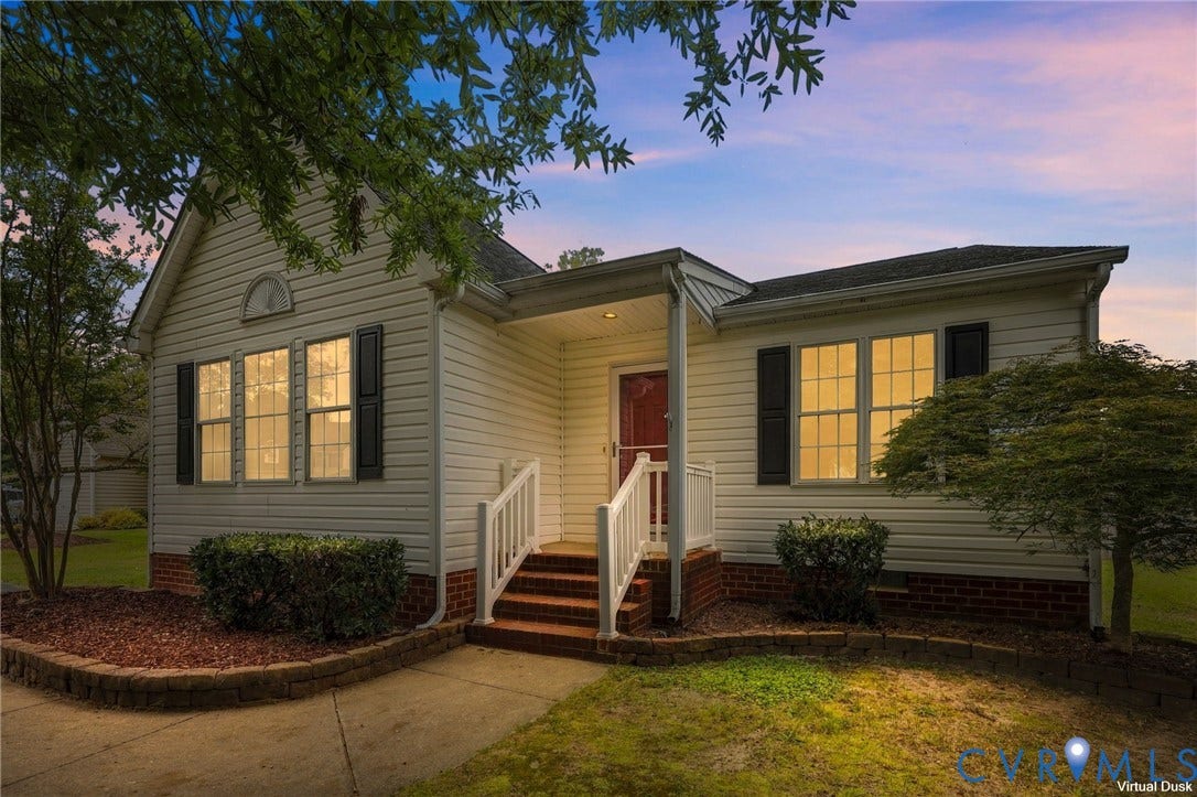 White siding exterior with black shutters and red brick accents