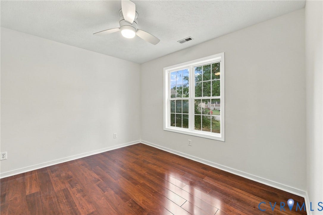 Wood-finish flooring, white trim, recessed lighting, and a ceiling fan with integrated illumination