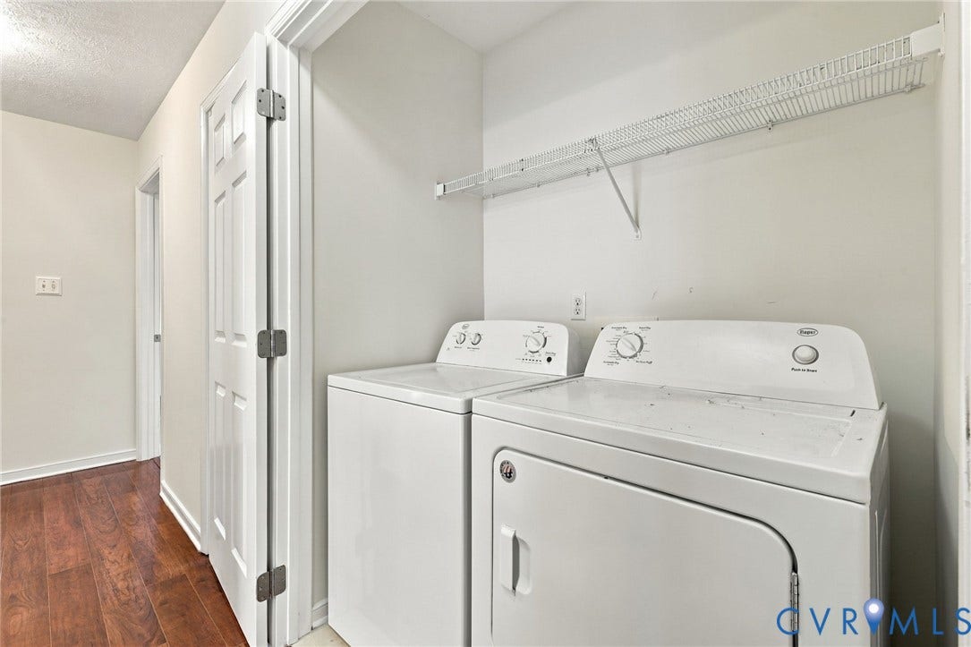 Laundry area featuring a wire storage shelf and white appliances