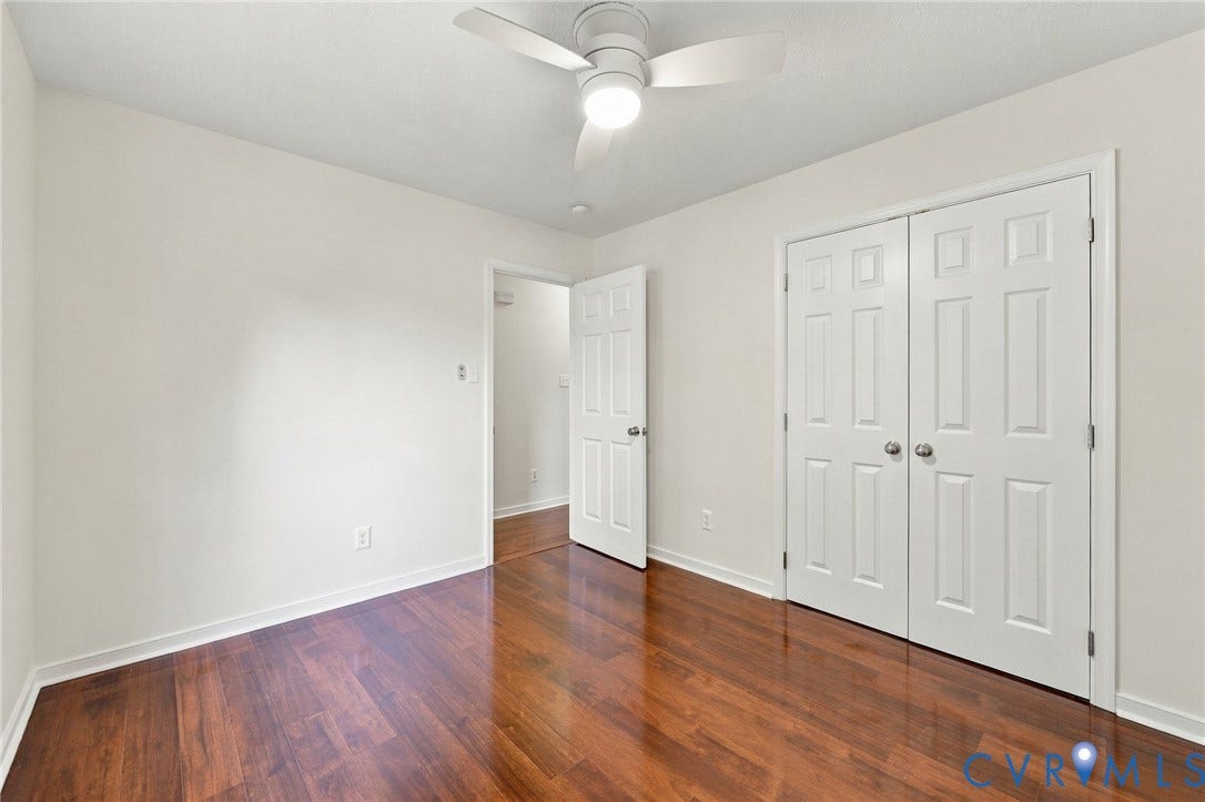 Wood-finish flooring with white baseboards