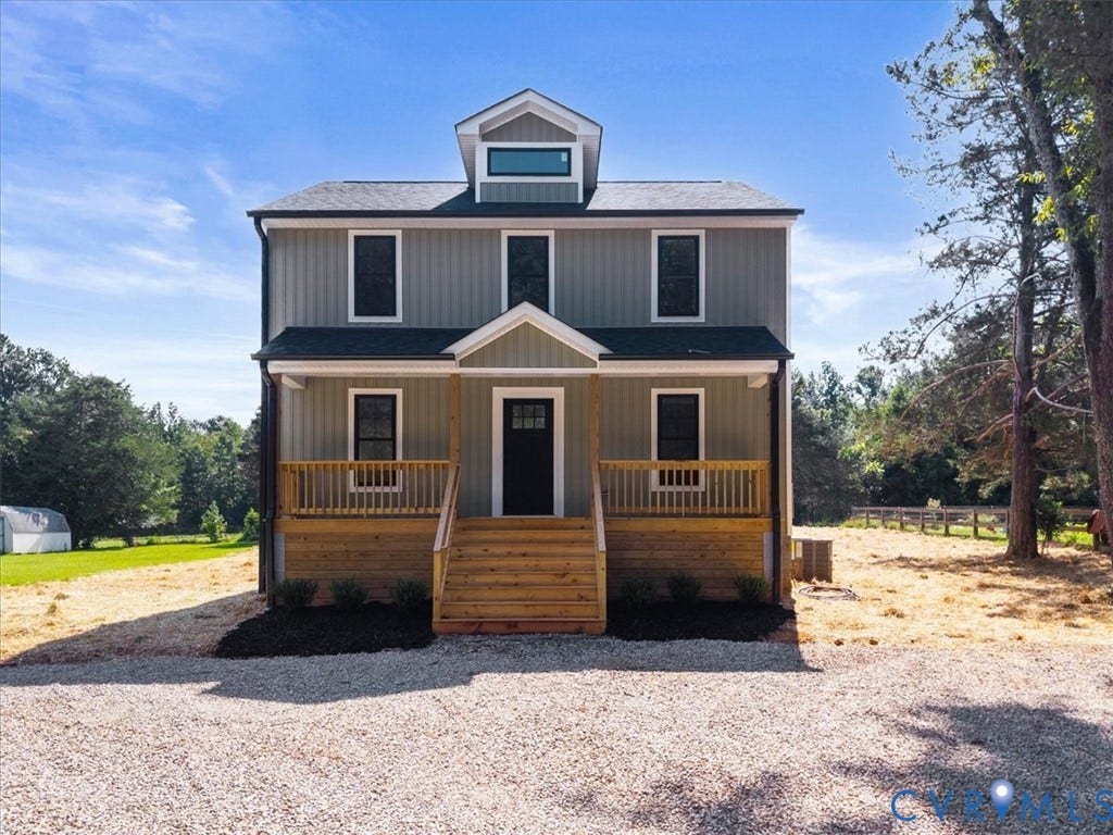 2242 Lakeview Drive, Powhatan, VA 23139 Two-story exterior with board and batten siding, dormer window, covered porch, wood stairs, and gravel driveway