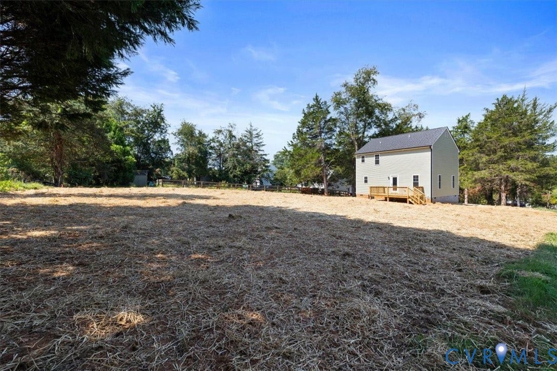 2242 Lakeview Drive, Powhatan, VA 23139 Expansive property featuring a newly constructed residence, a dark-pitched roof, light-colored siding, and a wooden deck with stairs