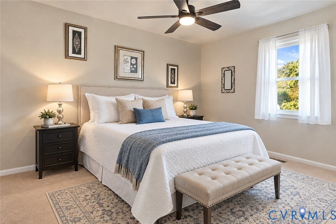 Bedroom featuring neutral wall colors, carpeting, a ceiling fan, and a window with natural light