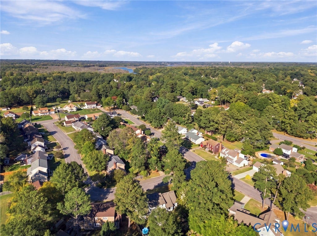 Aerial perspective showcasing a residential area with mature trees