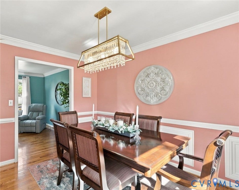 Hardwood flooring, crystal chandelier, decorative wall molding, and crown molding
