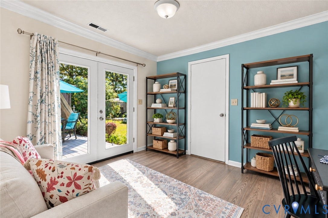 Wood-finish flooring, crown molding, and a light blue accent wall SOME VIRTUAL STAGING