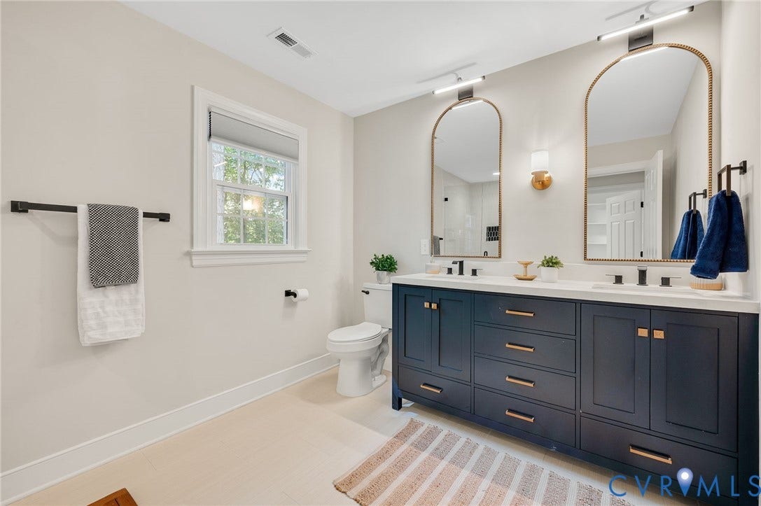 13800 W Salisbury Road, Salisbury, Midlothian, VA 23113 Dual vanity with dark wood-finish cabinetry and gold-tone hardware