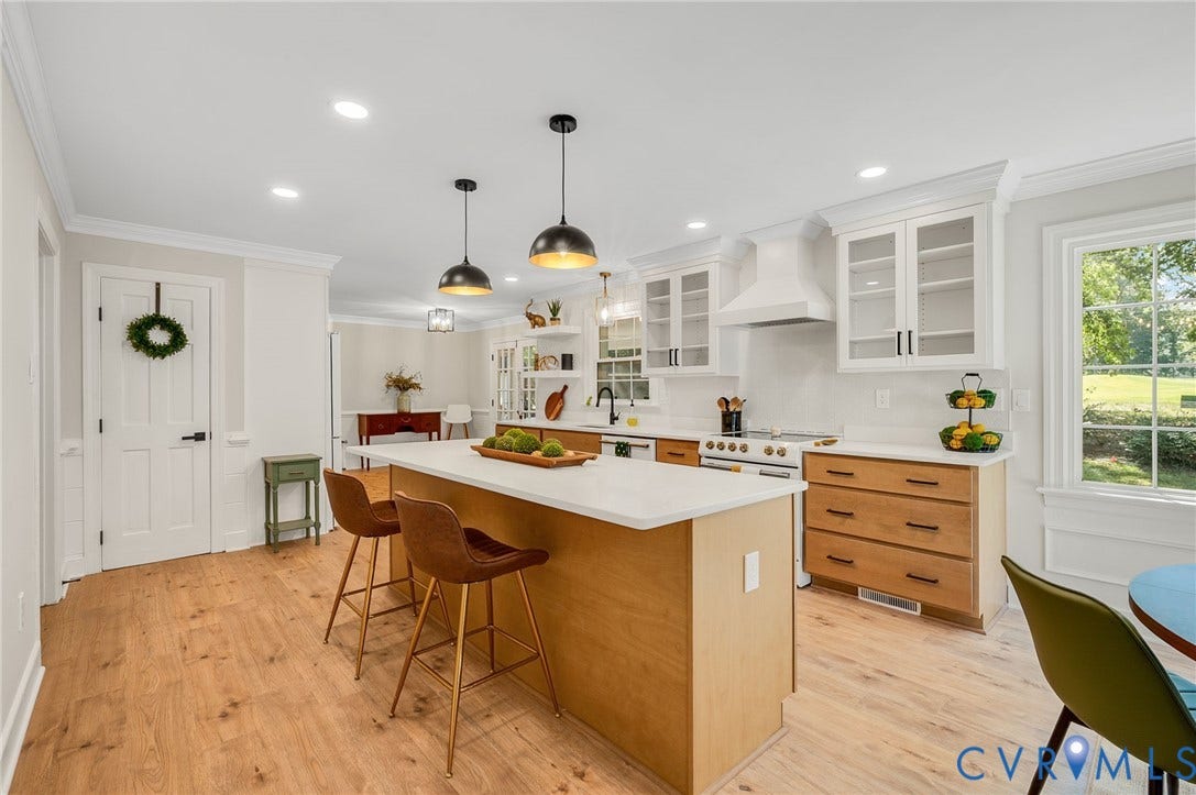 13800 W Salisbury Road, Salisbury, Midlothian, VA 23113 Wood-finish flooring throughout, bright white walls, modern pendant lighting, white shaker-style cabinetry with glass fronts, and a built-in range hood