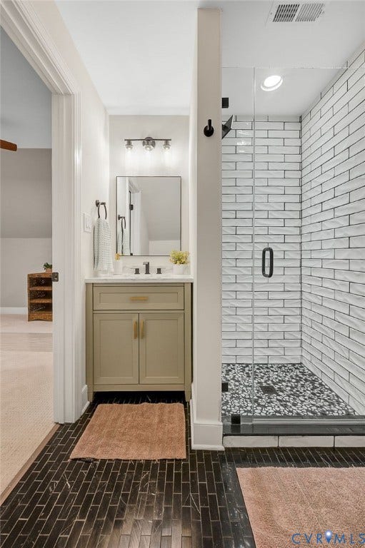 13800 W Salisbury Road, Salisbury, Midlothian, VA 23113 Walk-in shower with textured subway tile surround, pebble tile floor, and glass enclosure