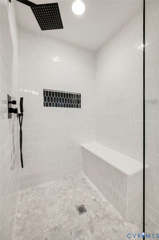 13800 W Salisbury Road, Salisbury, Midlothian, VA 23113 Shower featuring matte black rainfall showerhead and fixtures, built-in bench, hexagon tile accent niche, and mosaic tile flooring