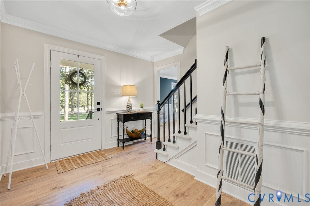 13800 W Salisbury Road, Salisbury, Midlothian, VA 23113 Foyer featuring wood-finish flooring, wainscoting, a paneled front door with glass inserts, a staircase with dark balusters, and a decorative ceiling light fixture