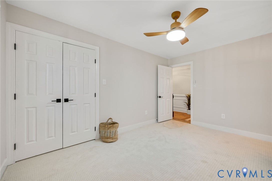 13800 W Salisbury Road, Salisbury, Midlothian, VA 23113 Light-toned carpeting, white paneled doors with matte black hardware, and a ceiling fan with integrated lighting