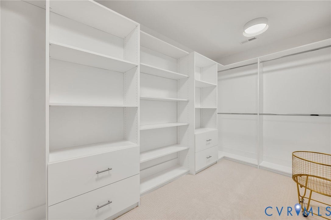 13800 W Salisbury Road, Salisbury, Midlothian, VA 23113 Custom white built-in shelving, integrated drawers with brushed nickel hardware, and multiple hanging rods provide storage