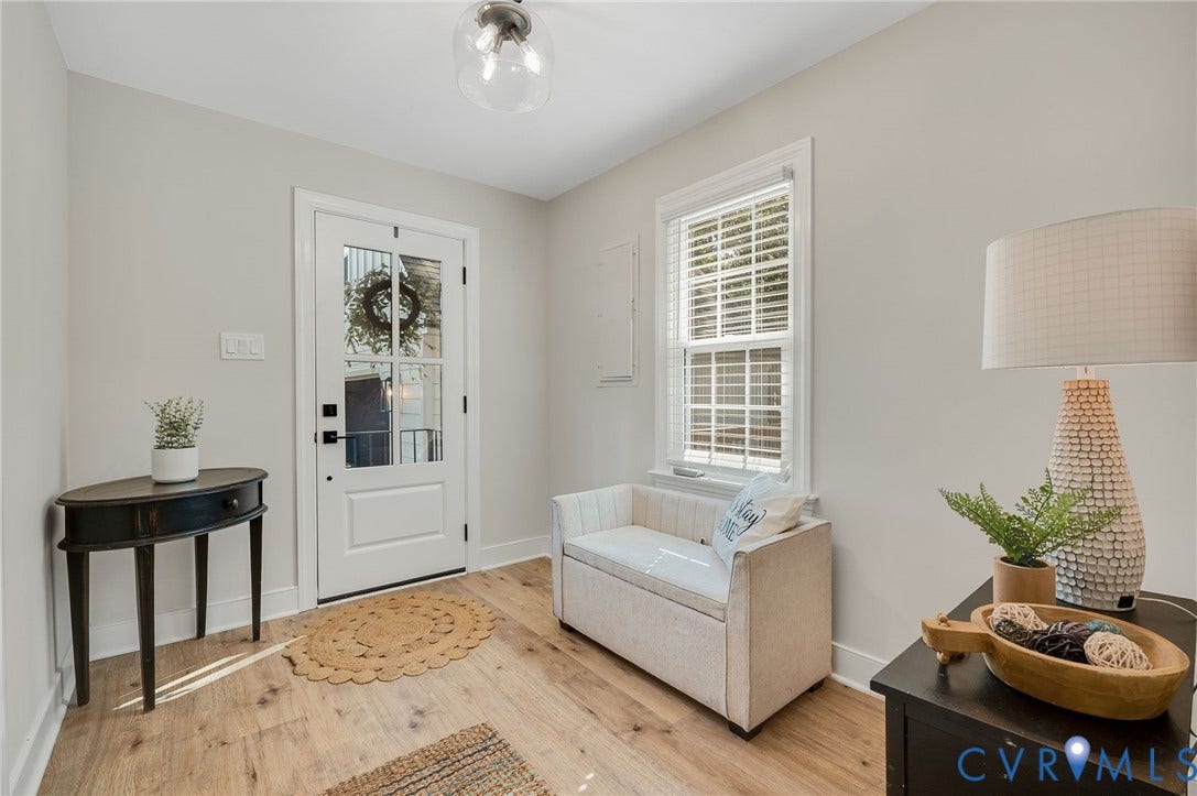 13800 W Salisbury Road, Salisbury, Midlothian, VA 23113 Bright foyer showcasing hardwood flooring, white trim detailing, and natural light from a multi-pane window