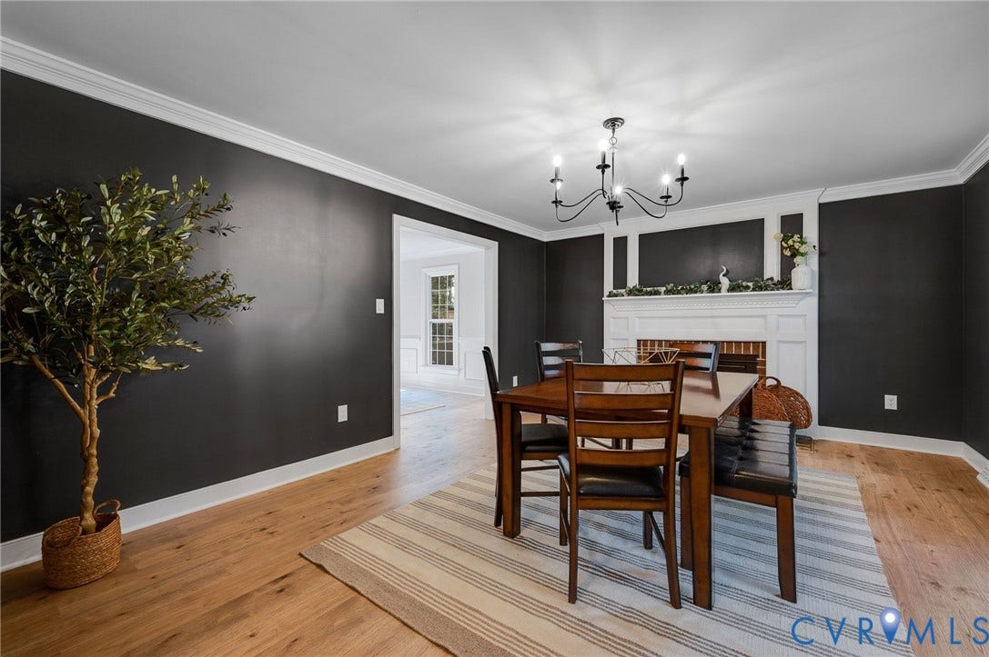 13800 W Salisbury Road, Salisbury, Midlothian, VA 23113 Hardwood flooring, crown molding, white trim, a decorative fireplace, and a chandelier