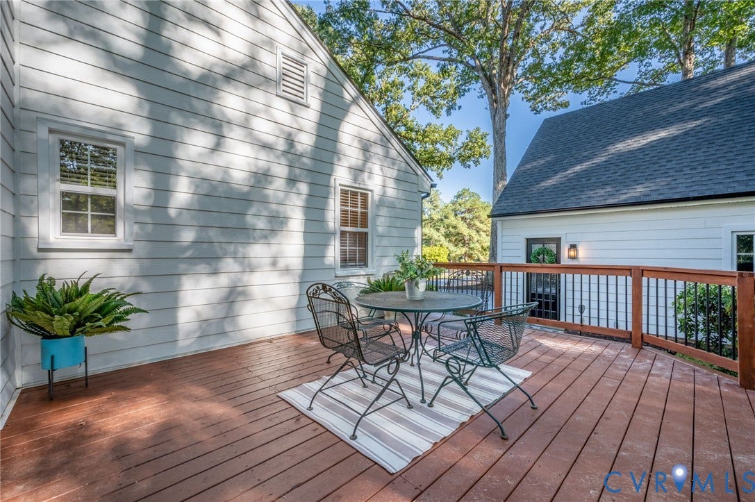 13800 W Salisbury Road, Salisbury, Midlothian, VA 23113 Expansive outdoor deck with rich wood-finish flooring, a dark wood railing, and black metal balusters