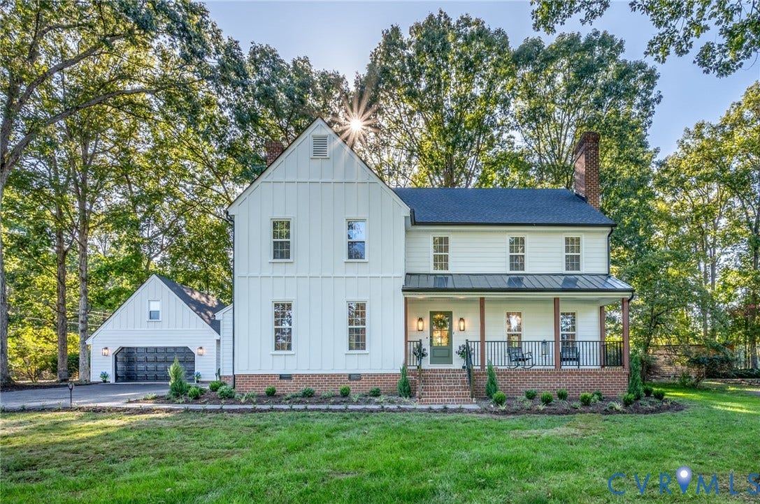 13800 W Salisbury Road, Salisbury, Midlothian, VA 23113 Two-story residence featuring white board and batten siding, a dark roof, and a covered front porch with brick accents
