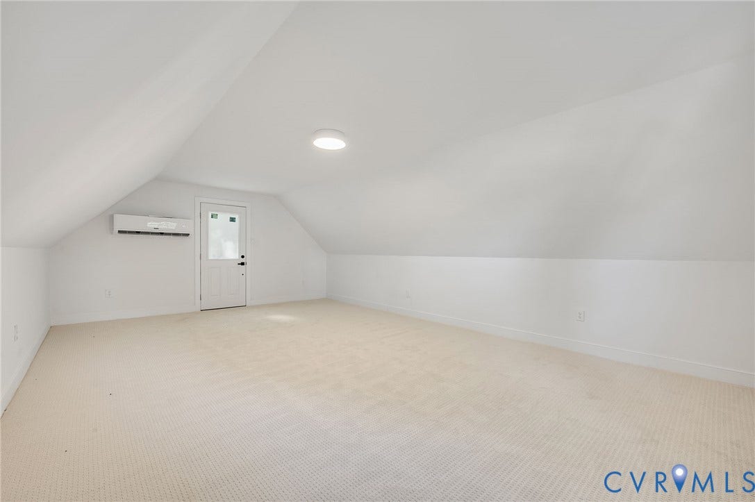 13800 W Salisbury Road, Salisbury, Midlothian, VA 23113 Expansive attic space featuring light-colored carpeting, sloped ceilings, and a wall-mounted mini-split HVAC unit