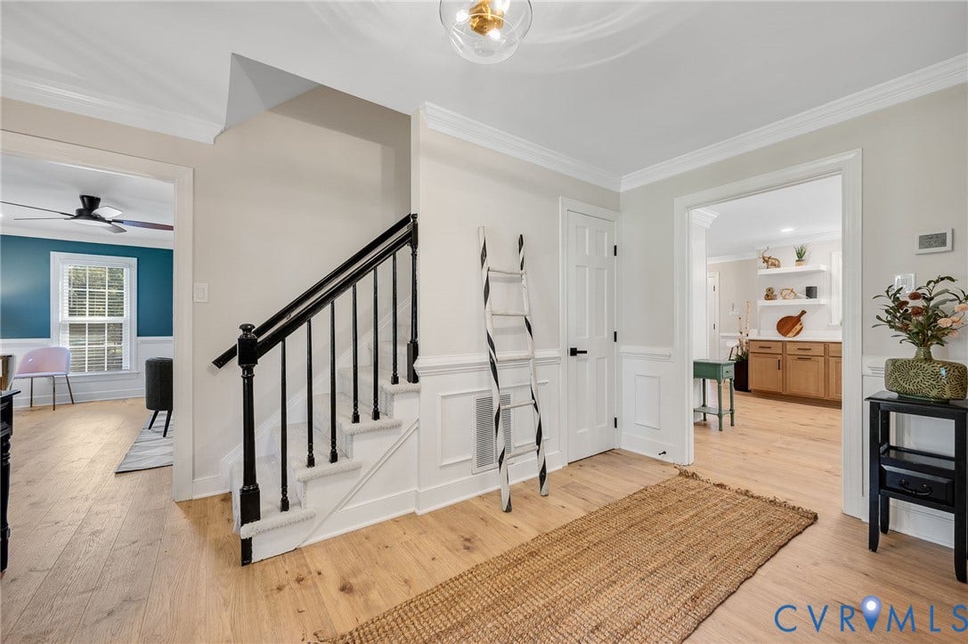 13800 W Salisbury Road, Salisbury, Midlothian, VA 23113 Wood-finish flooring throughout, wainscoting details, a staircase with dark balusters, crown molding, and an overhead light fixture