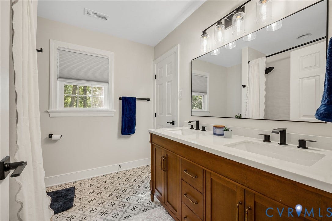 13800 W Salisbury Road, Salisbury, Midlothian, VA 23113 Double vanity with white countertops, undermount sinks, and matte black fixtures