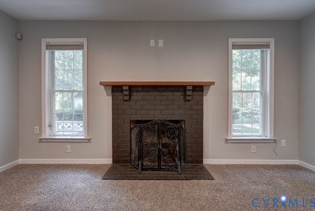 8113 Ainsdale Lane, Chesterfield, VA 23832 Brick fireplace with a wood-finish mantel and hearth, flanked by two single-hung windows