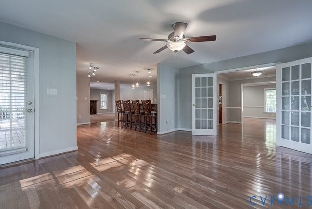 8113 Ainsdale Lane, Chesterfield, VA 23832 Sitting Room with French Doors leading to the Dining Room. Wood-finish flooring, ceiling fan with light fixture, French doors, recessed lighting, and a kitchen island with pendant lighting