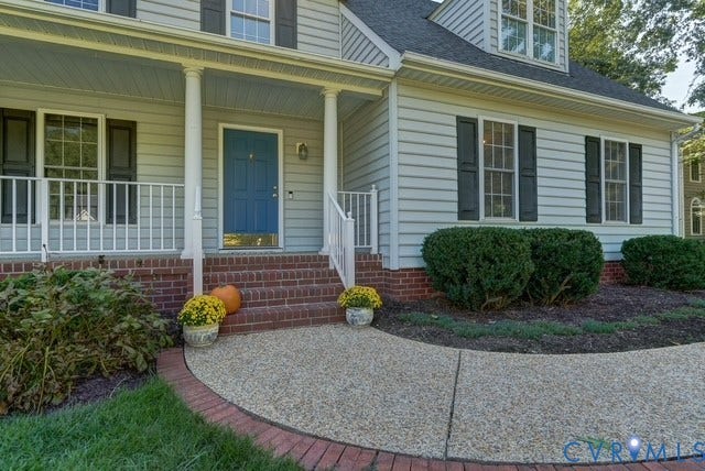 8113 Ainsdale Lane, Chesterfield, VA 23832 Light-colored siding exterior with dark shutters, brick foundation, and a covered porch