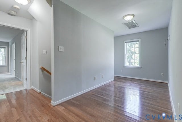 8113 Ainsdale Lane, Chesterfield, VA 23832 Hardwood flooring, light gray wall tones, natural light from a window, and white trim