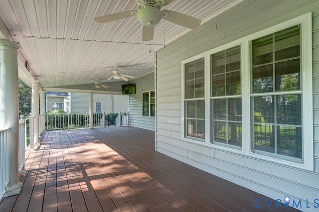 8113 Ainsdale Lane, Chesterfield, VA 23832 Expansive covered porch featuring wood-finish flooring, white architectural columns, multiple ceiling fans, horizontal siding, and multiple large windows