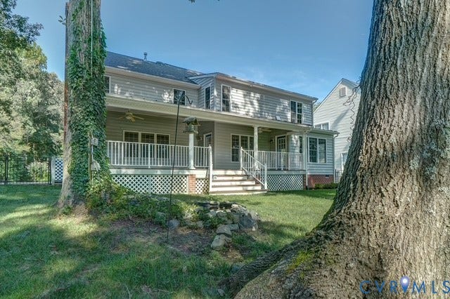 8113 Ainsdale Lane, Chesterfield, VA 23832 Rear exterior with a covered porch, white railing, and a fenced perimeter