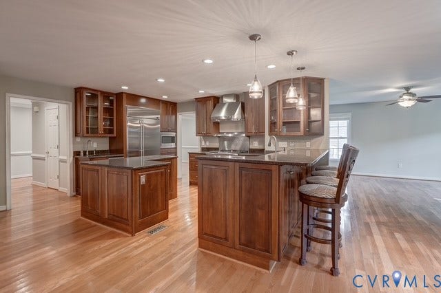 8113 Ainsdale Lane, Chesterfield, VA 23832 Chef's Kitchen featuring gas Wolf range, ice maker, beverage fridge, large island, pre sink and more!
